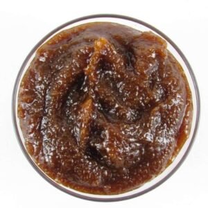 A glass bowl of JBHomemade Sugaring and Skin Care's Natural Pumpkin Vanilla Brown Sugar Body Scrub.