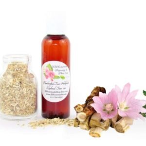 A bottle of JBHomemade’s handcrafted hollyhock water toner, made with organic marshmallow root and fresh hollyhock blooms, accompanied by dried marshmallow root and a vibrant hollyhock flower.