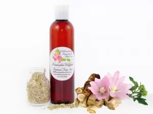 JBHomemade Hollyhock Hydrosol Toner 8 oz A bottle of JBHomemade’s handcrafted hollyhock water toner, made with organic marshmallow root and fresh hollyhock blooms, accompanied by dried marshmallow root and a vibrant hollyhock flower.