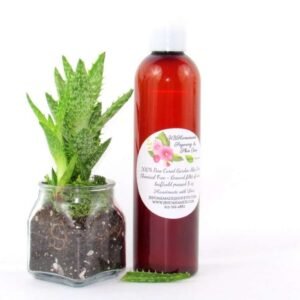 An 8 oz amber bottle of Pure Aloe Vera product, enriched and authentic, surrounded by fresh aloe vera leaf pieces, showcasing the natural ingredients and the premium quality of the product.