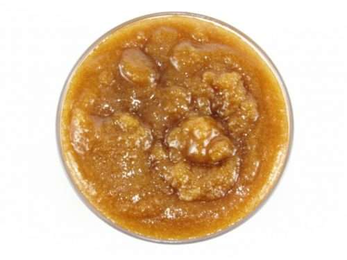 A glass bowl of JBHomemade Sugaring and Skin Care's Natural Vanilla Aloe Brown Sugar Body Scrub.
