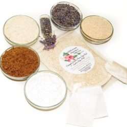 An 8 oz zip pouch of JBHomemade’s Lavender Oatmeal Bath Soak, A selection of natural ingredients including whole oats, brown sugar, colloidal oatmeal, baking soda, and lavender displayed in separate bowls to highlight their purity and quality.