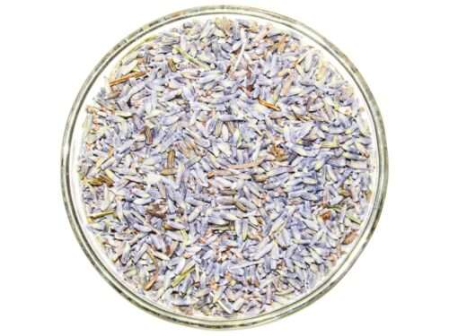 A top view of dried lavender buds, rich in color and aroma, neatly presented in a clear glass bowl.
