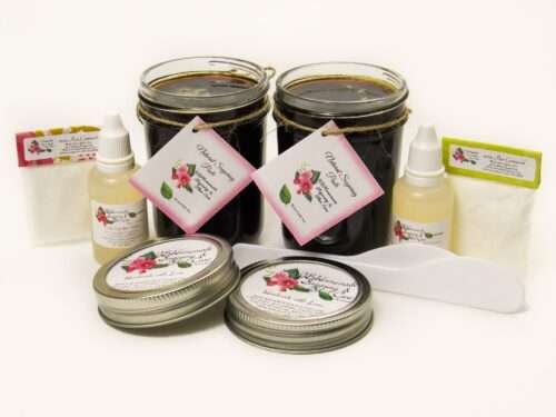 Two 8 oz masons (16 oz) of JBHomemade Sugaring Paste are presented with its included pouches of cornstarch, bottles of aloe vera and applicators.