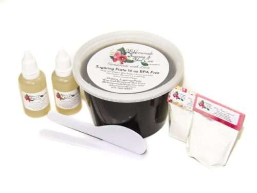 A 16-ounce tub of JBHomemade Sugaring Paste is presented with its included pouches of cornstarch, bottles of aloe vera and applicators.