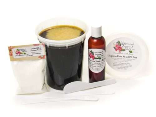 A 32 oz tub of JBHomemade Sugaring Paste is presented with its included large pouch of cornstarch and arrowroot powder, bottle of aloe vera and applicators.
