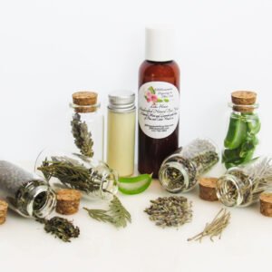 Front View of an all-natural facial cleanser in an amber bottle surrounded by six small, corked glass bottles containing sprinkles of pine, cedarwood, spearmint, and lavender ingredients. A clear glass bottle showcases the face wash’s color and texture.