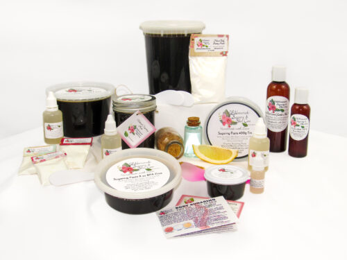 A collection of sugaring paste containers, including various sizes (16 Oz, 2 Oz, 24 Oz, 32 Oz, 400g Tin, and 8 Oz). The image features labeled bottles of pure aloe vera and pouches of cornstarch, along with a business card, an instruction pamphlet, lemon slices, and raw sugar. A clear glass bottle of crystal blue purified water represents the natural ingredients.