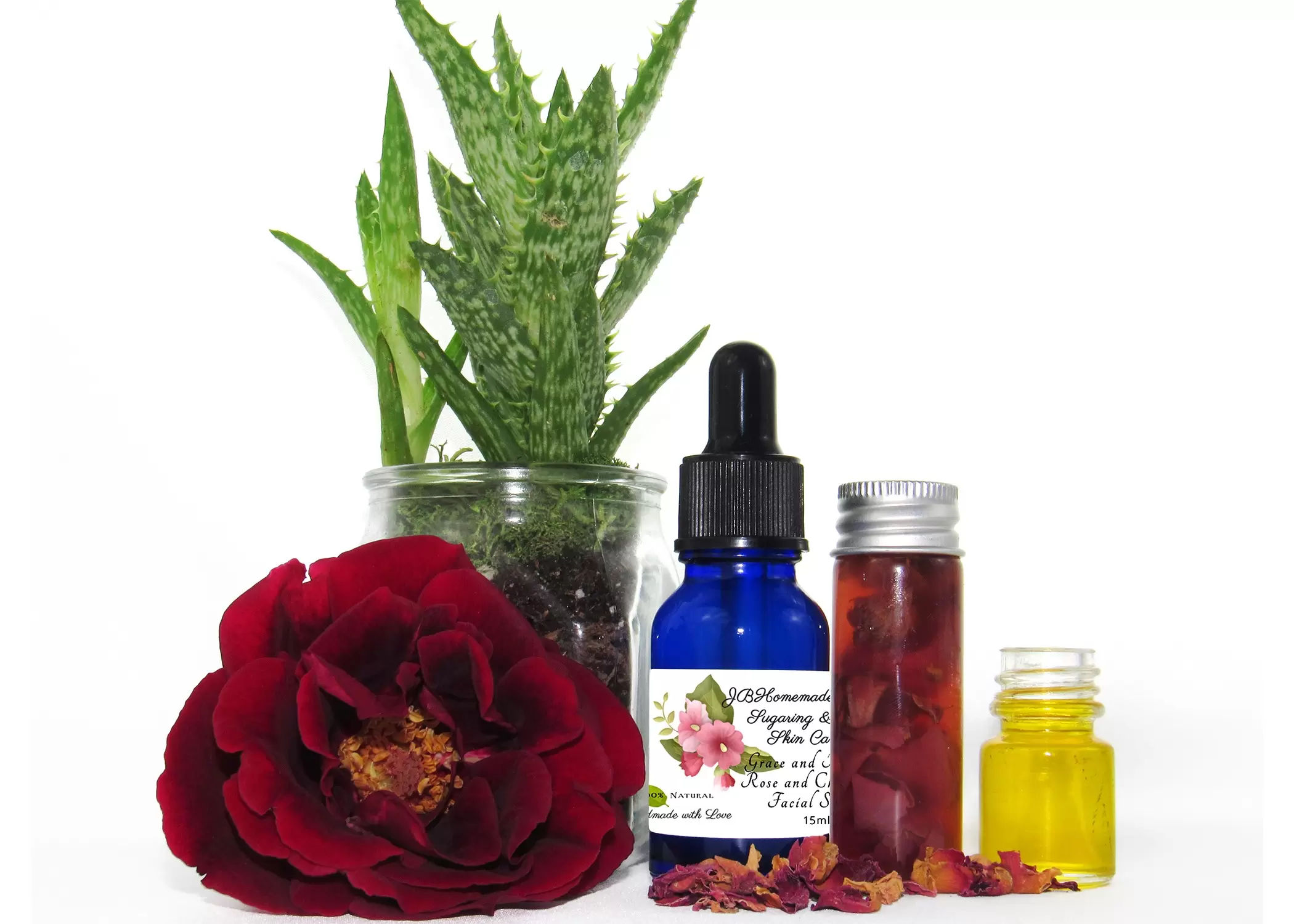 A closeup view of the cobalt blue bottle of Grace and Presence Rose and Chamomile Facial Serum. The label is prominently displayed, and the bottle exudes elegance.