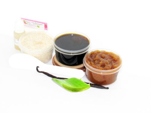 The home sugaring hair removal starter kit comes with a 2 oz tub of firm sugaring paste, a tub of Vanilla Aloe Brown Sugar Body Scrub, a tub of Colloidal Oatmeal Brown Sugar Dry Body Scrub, a small bottle of pure aloe vera, a pouch of cornstarch, an applicator, along with a vanilla bean and a slice of aloe plant for illustration.