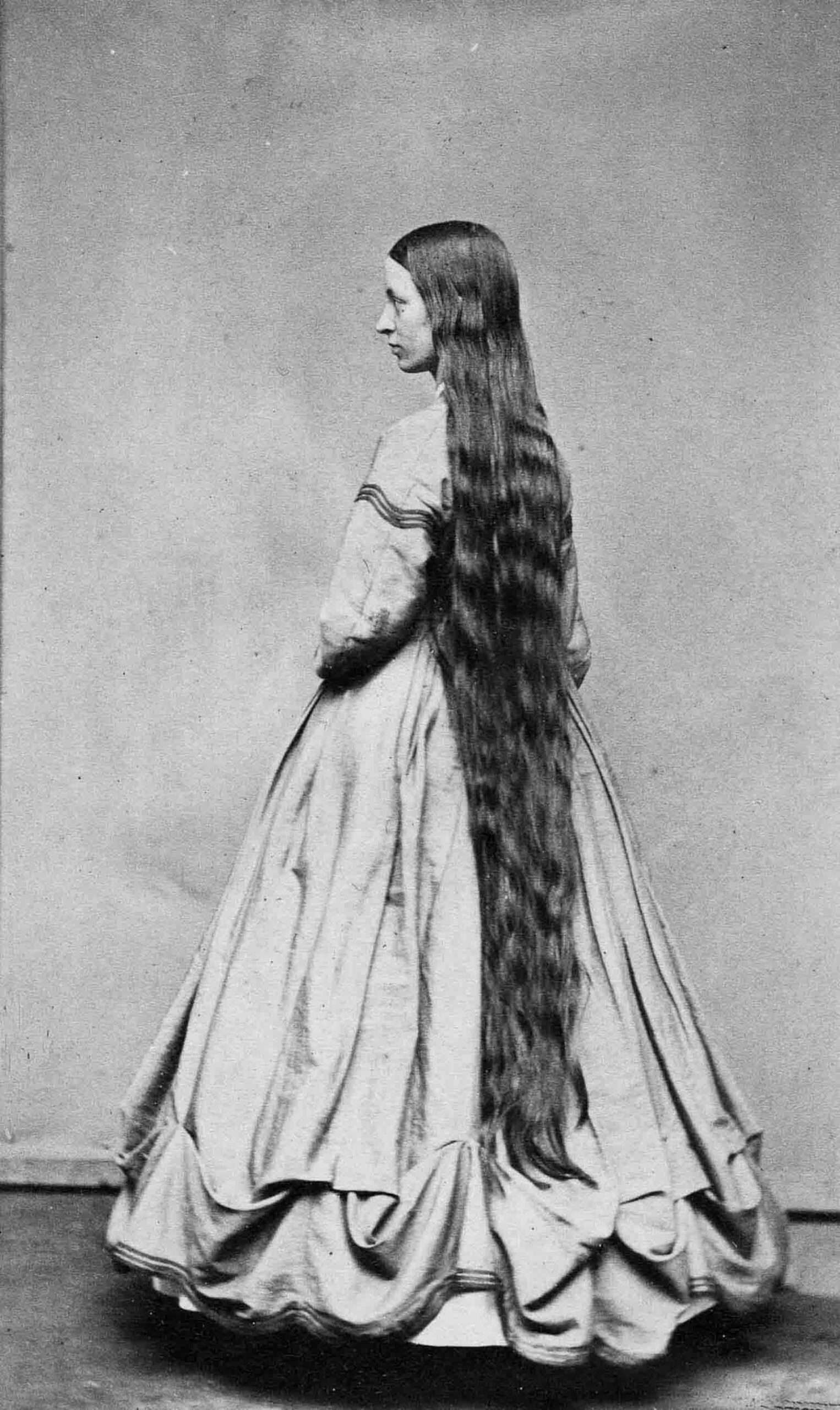 Victorian era woman with long hair touching the floor, signifying status and femininity